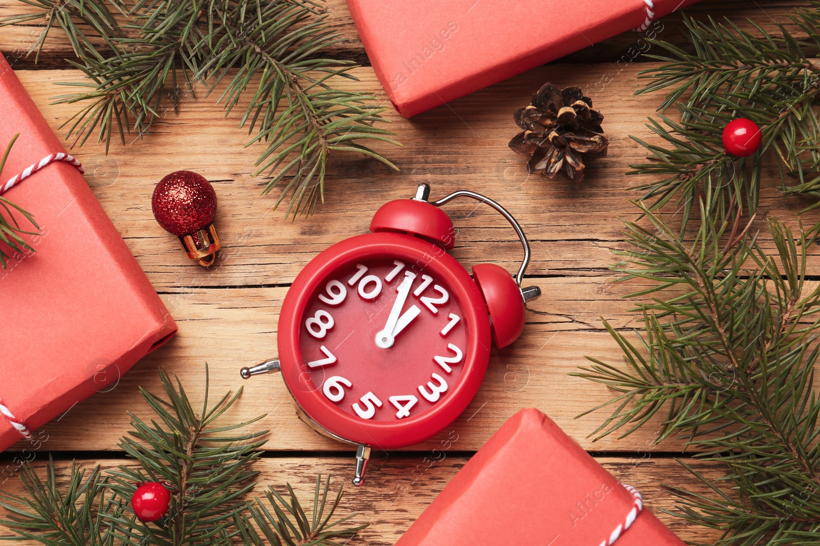 Photo of Flat lay composition with Christmas gifts and alarm clock on wooden table. Boxing day