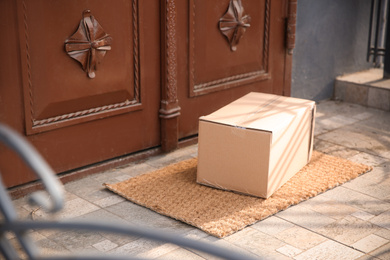 Photo of Delivered parcel on door mat near entrance