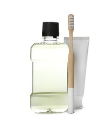 Mouthwash, toothbrush and paste on white background