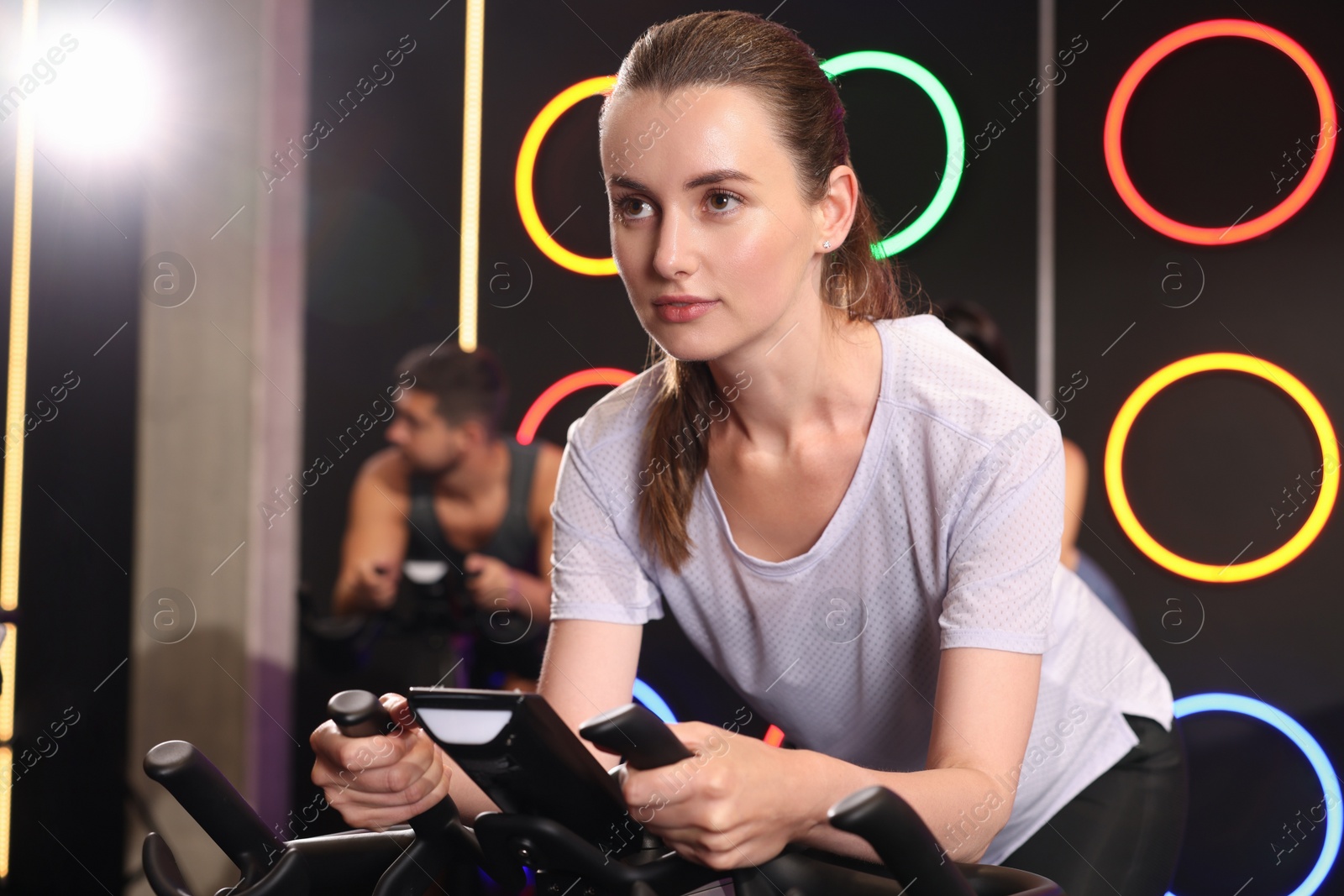 Photo of Group of people training on exercise bikes in fitness club