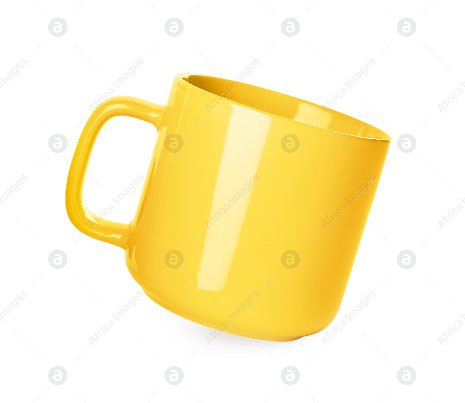 Photo of Clean yellow ceramic cup isolated on white