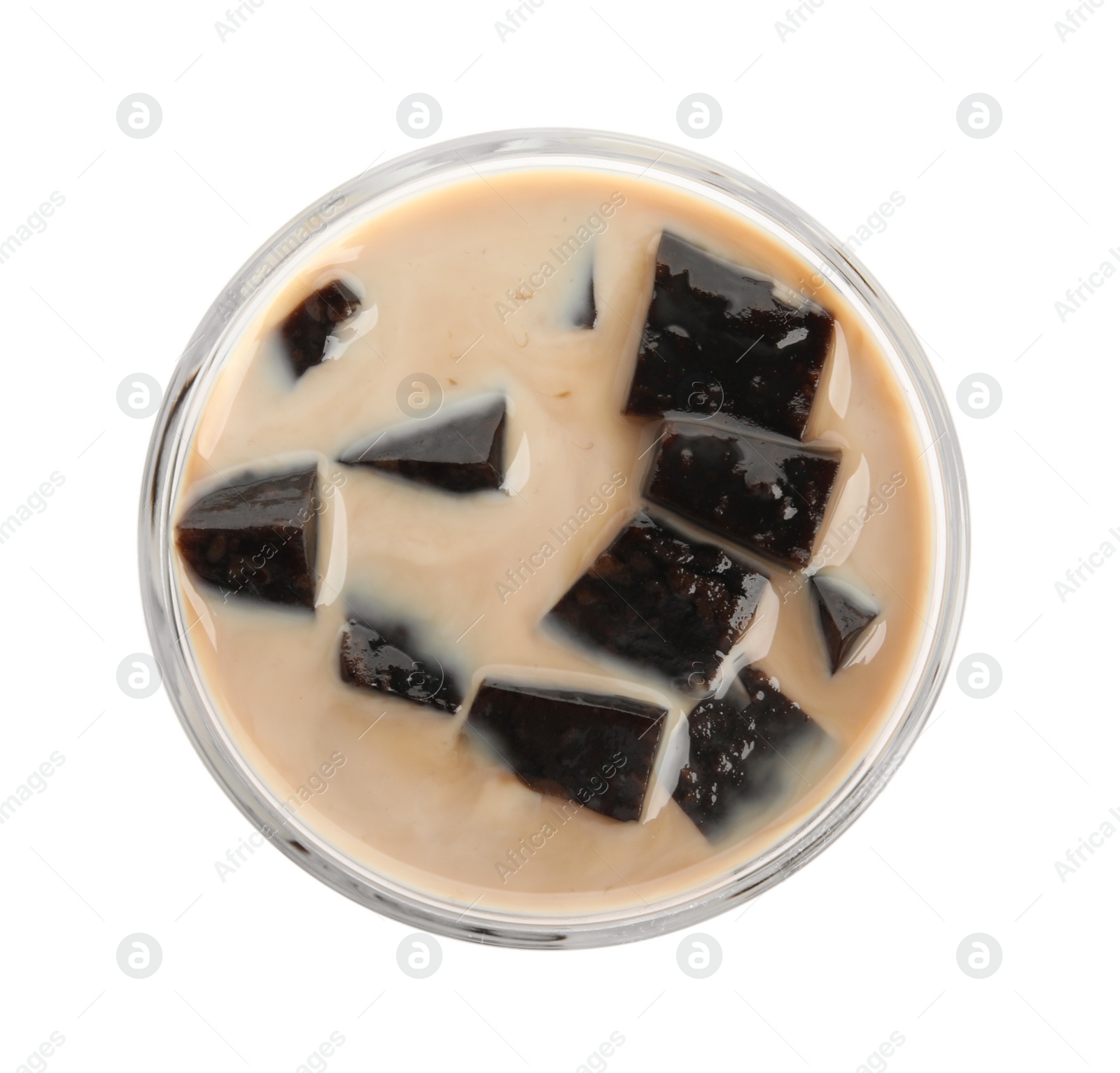 Photo of Glass of milk with grass jelly isolated on white, top view