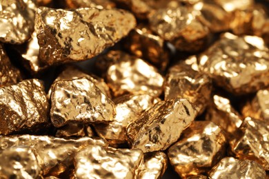 Photo of Pile of gold nuggets as background, closeup