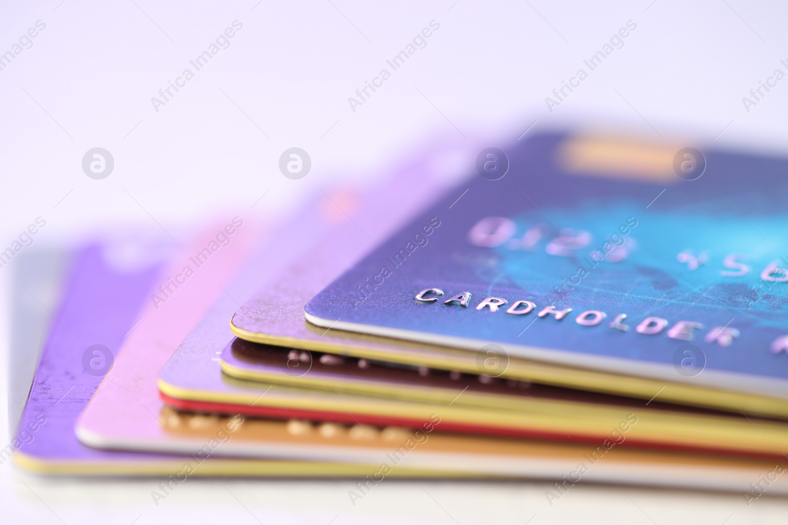 Photo of Plastic credit cards on blurred background, closeup view