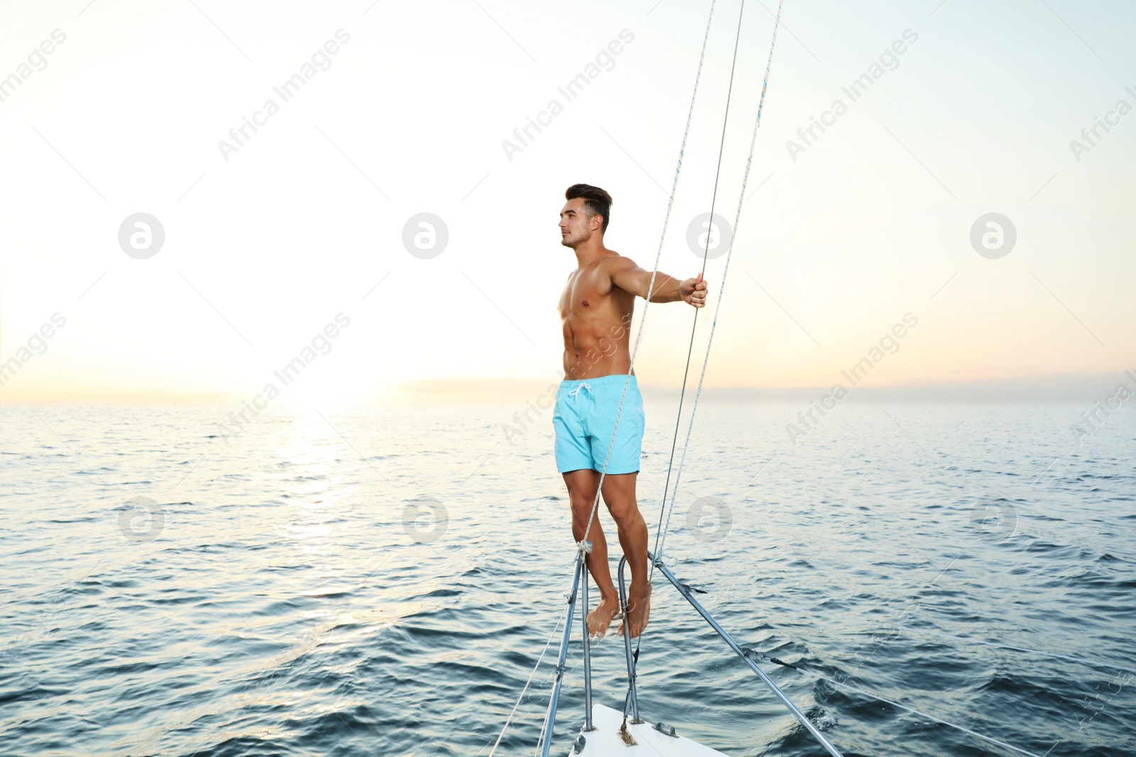 Photo of Young wealthy man on yacht enjoying sunset