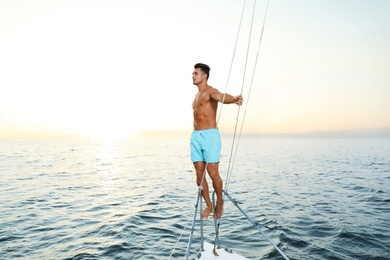 Young wealthy man on yacht enjoying sunset