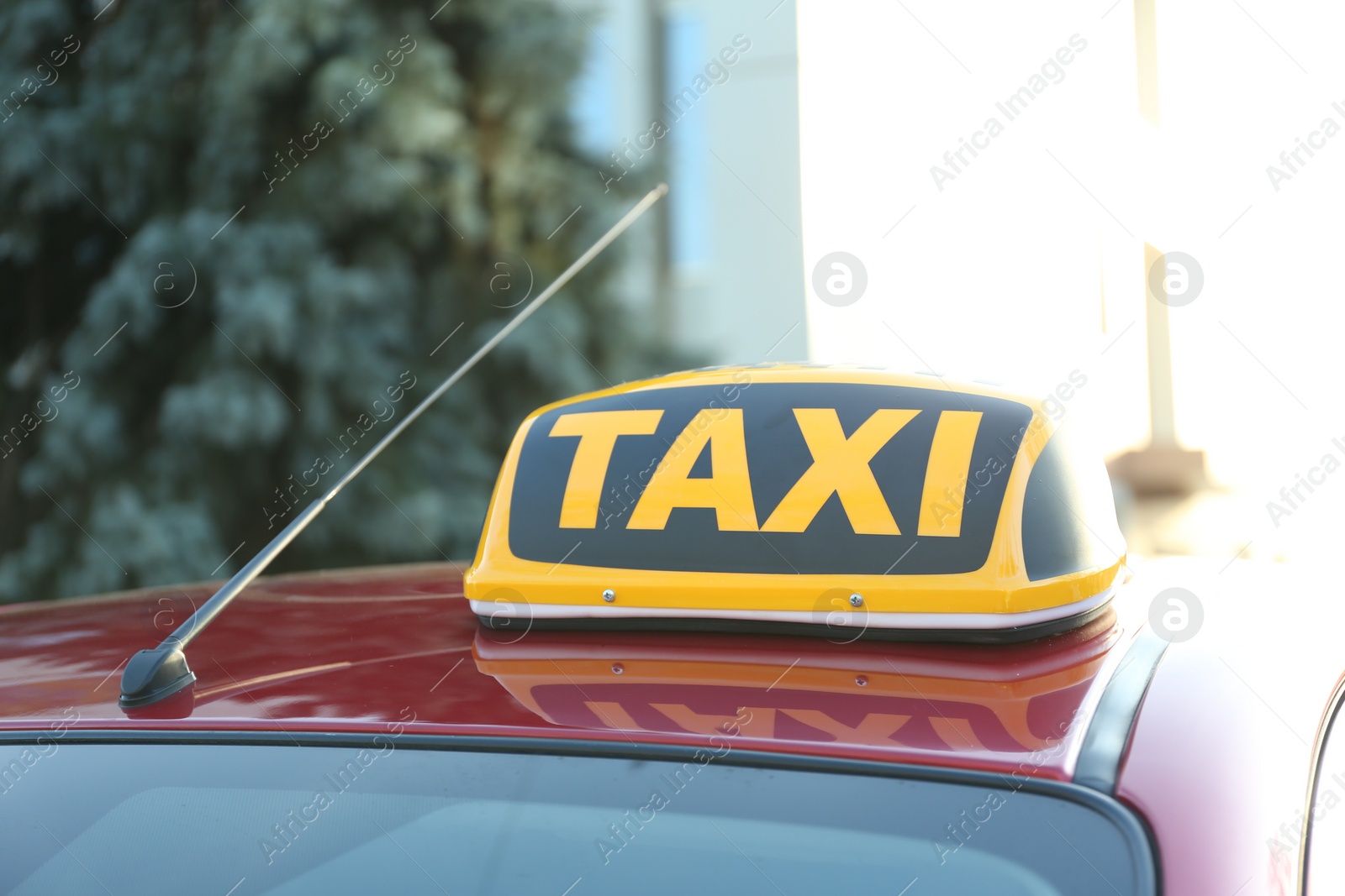 Photo of Roof light with word TAXI on car outdoors