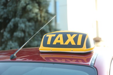 Photo of Roof light with word TAXI on car outdoors