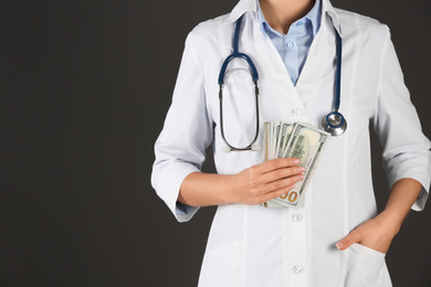 Photo of Doctor with bribe on black background, closeup. Corruption in medicine