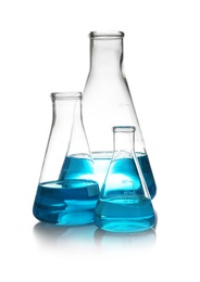 Photo of Conical flasks with liquid on table against white background. Laboratory analysis