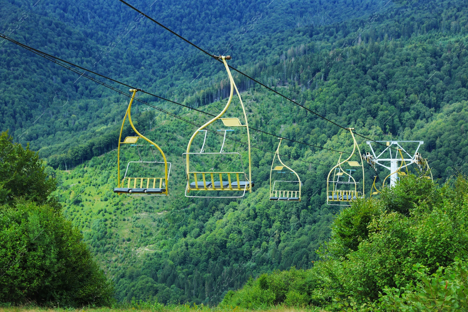 Photo of Chairlift with seats at beautiful mountain resort