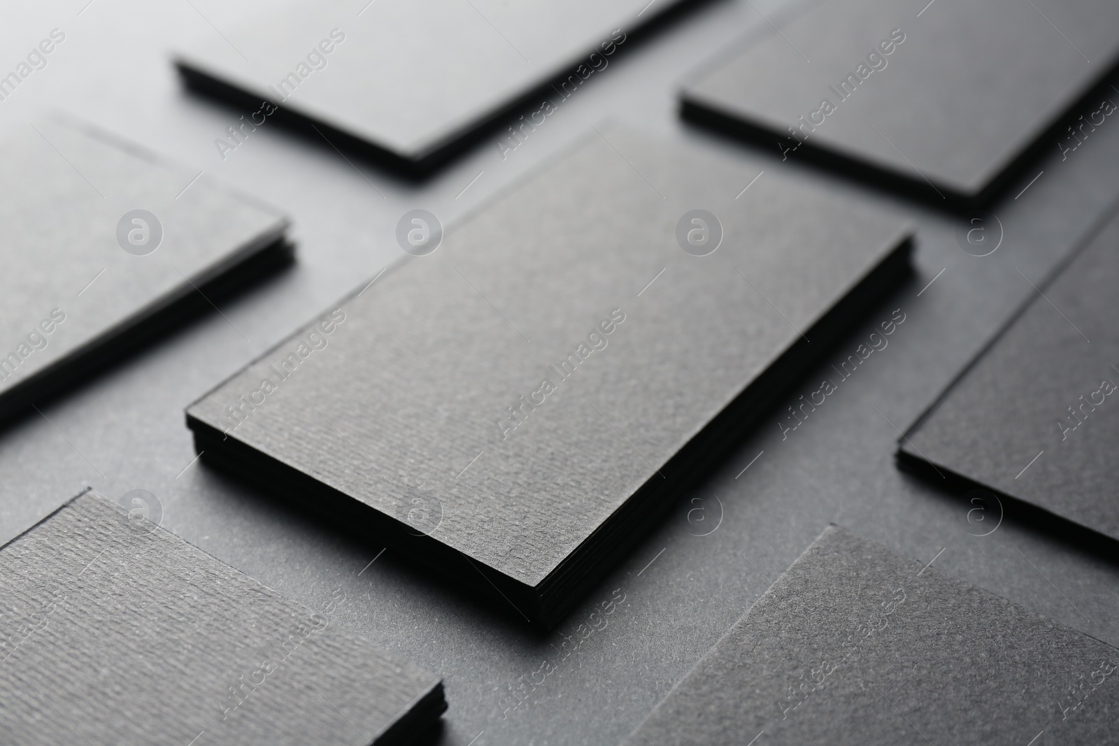 Photo of Blank business cards on black background, closeup. Mockup for design