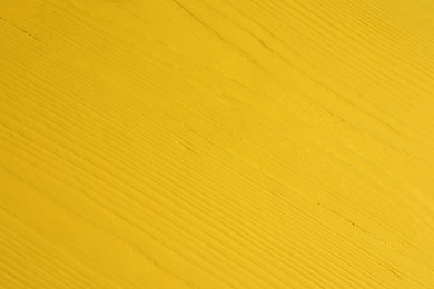 Photo of Texture of yellow wooden surface as background, closeup