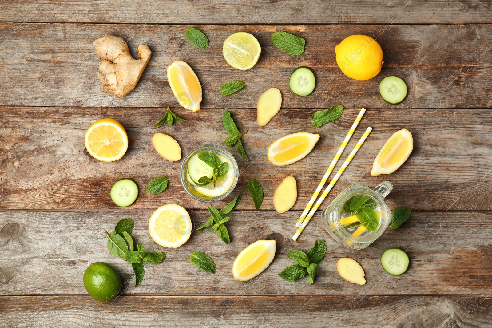 Photo of Flat lay composition with detox lemonade and ingredients on wooden background