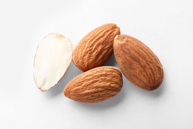 Photo of Organic almond nuts on white background, top view. Healthy snack