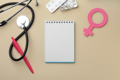Photo of Flat lay composition with female gender sign and stethoscope on beige background. Women's Health concept