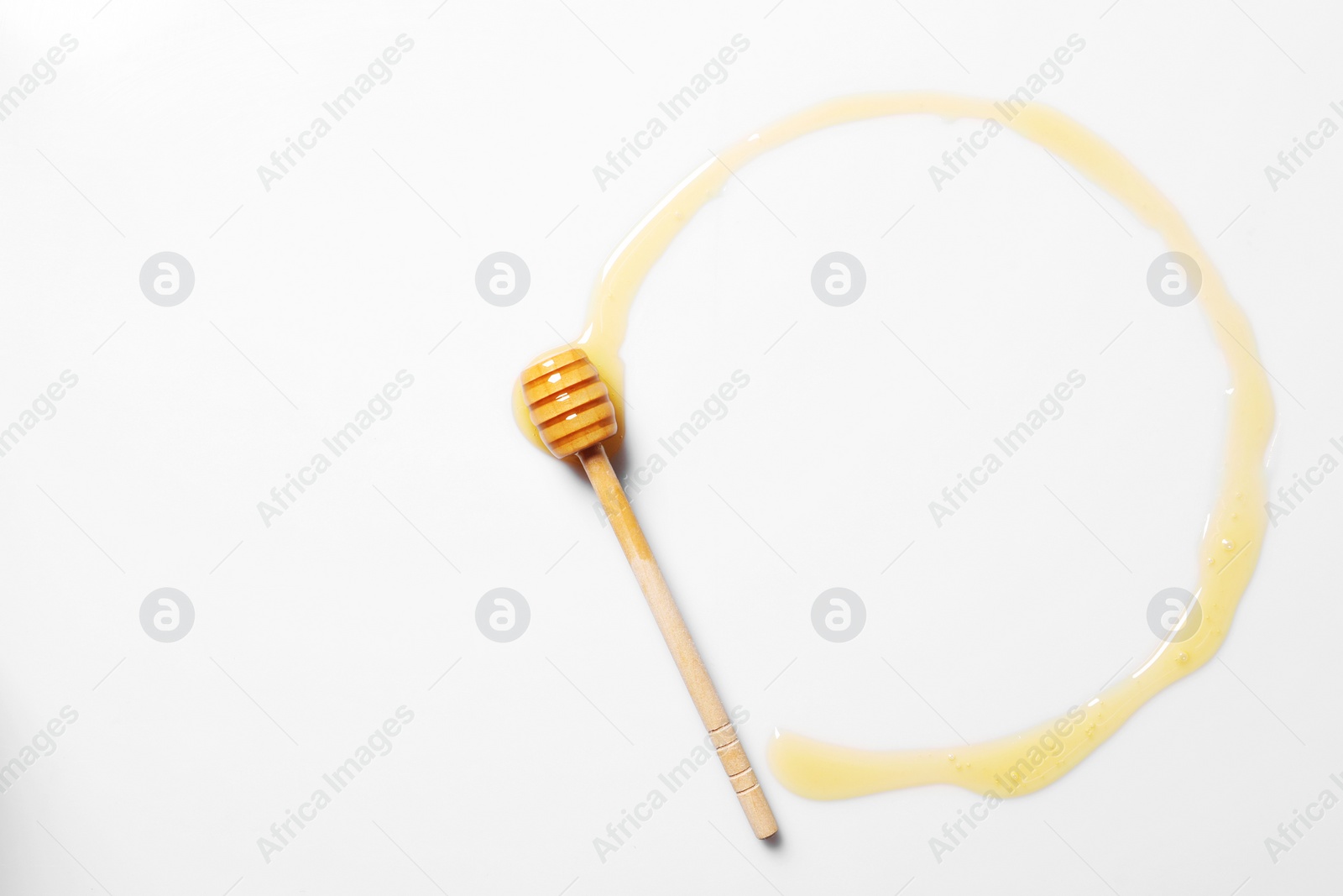 Photo of Tasty natural honey and dipper on white background, top view