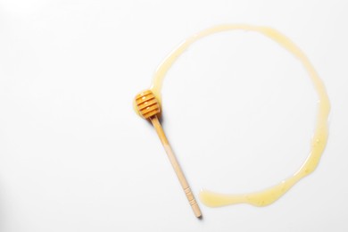 Photo of Tasty natural honey and dipper on white background, top view