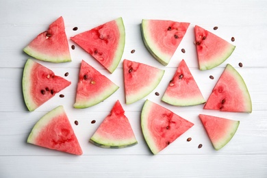 Photo of Watermelon slices on white wooden background, flat lay