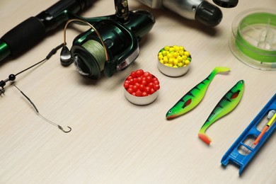 Modern fishing tackle on wooden background, closeup