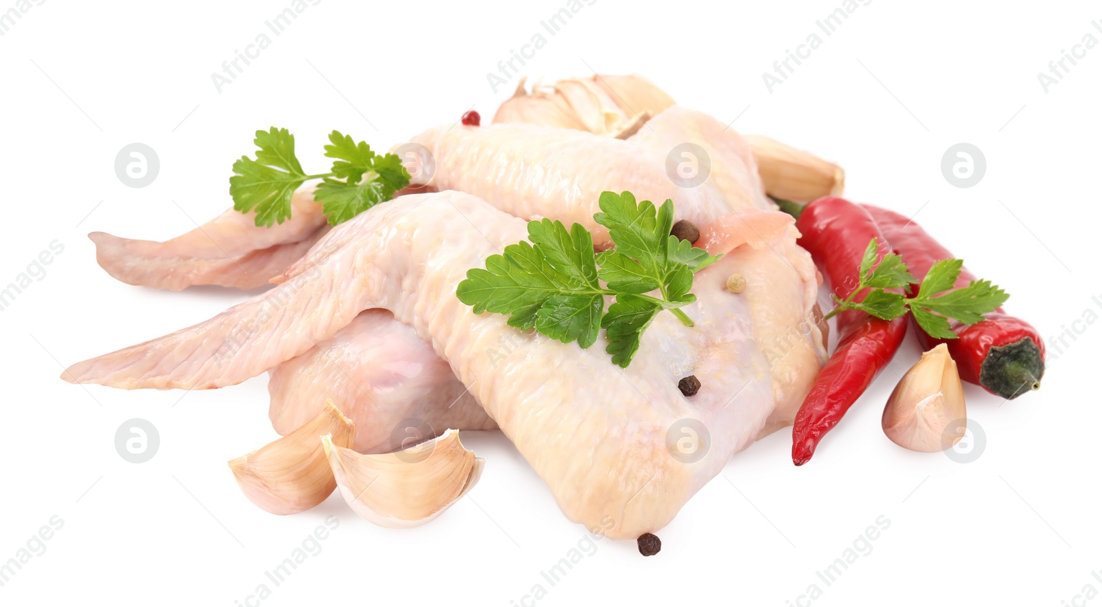 Photo of Raw chicken wings with spices and parsley on white background