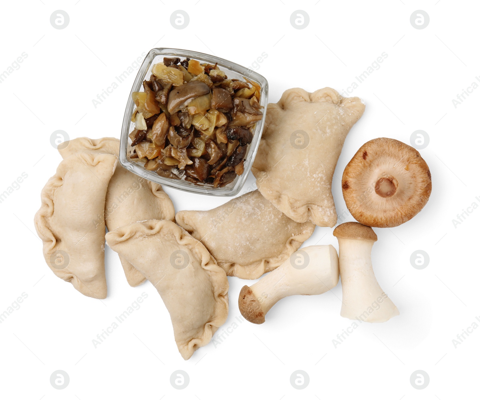 Photo of Raw dumplings (varenyky) and mushrooms isolated on white, top view