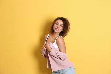 Photo of Beautiful woman in casual outfit on yellow background