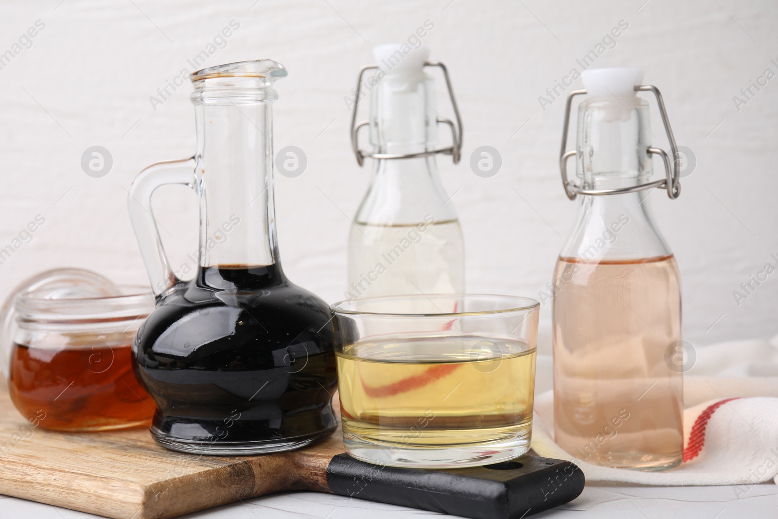 Photo of Different types of vinegar on white table