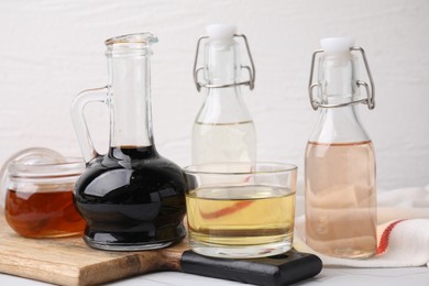 Different types of vinegar on white table