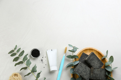 Photo of Flat lay composition of toothbrush with natural bristles on white table. Space for text