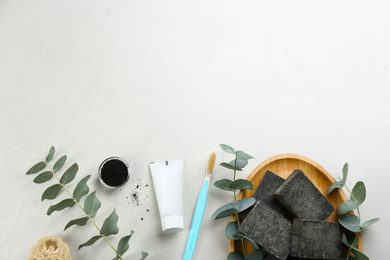 Flat lay composition of toothbrush with natural bristles on white table. Space for text