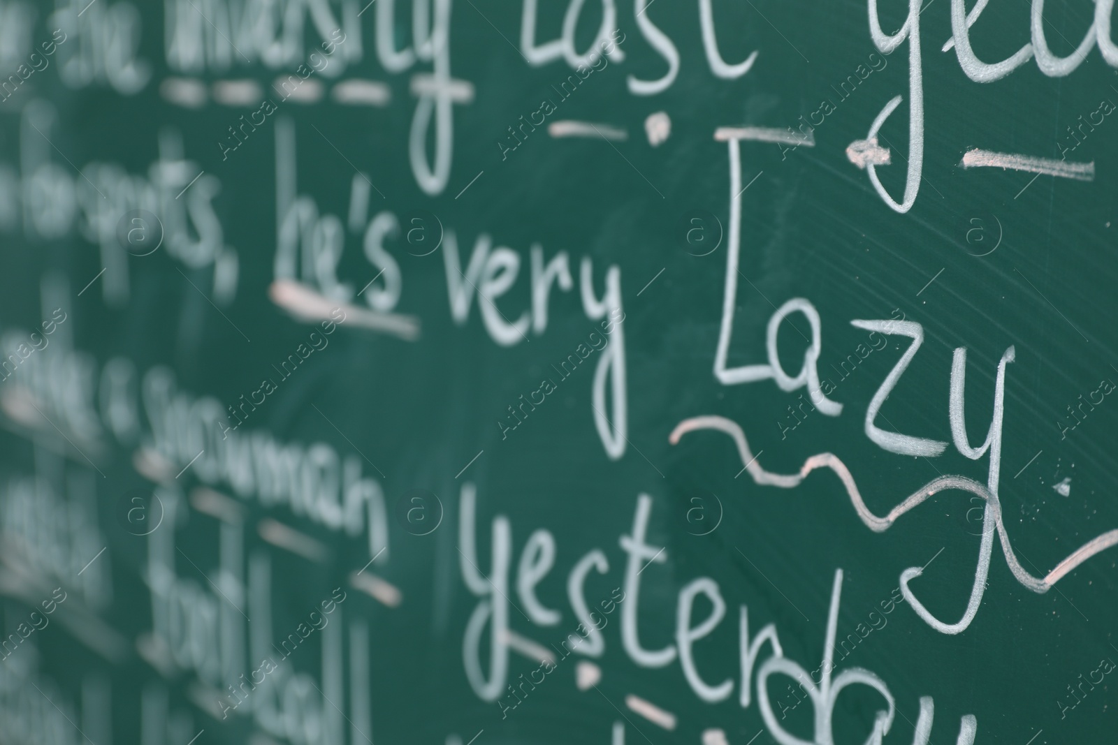 Photo of English grammar rules written with chalk on green board, closeup