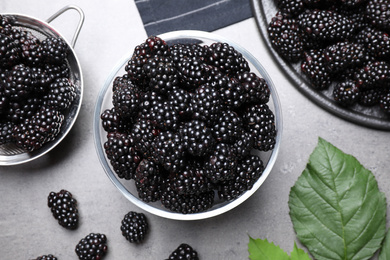 Photo of Fresh ripe blackberries on light grey table, flat lay