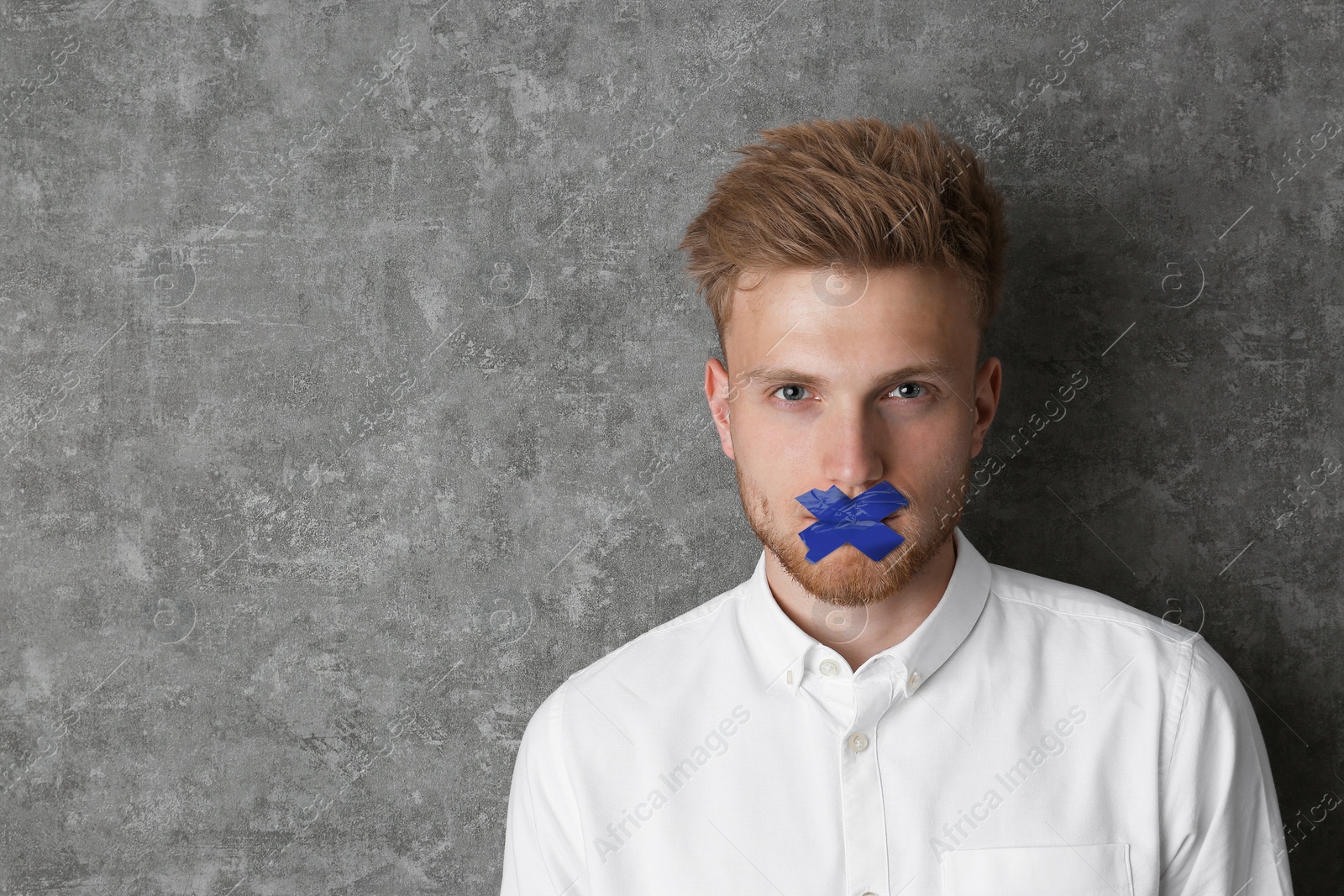 Image of Man with taped mouth on grey background, space for text. Speech censorship