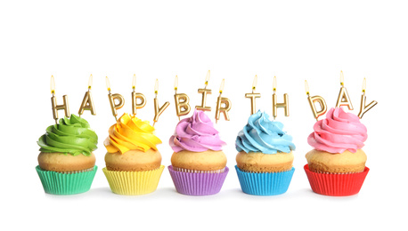 Birthday cupcakes with candles on white background