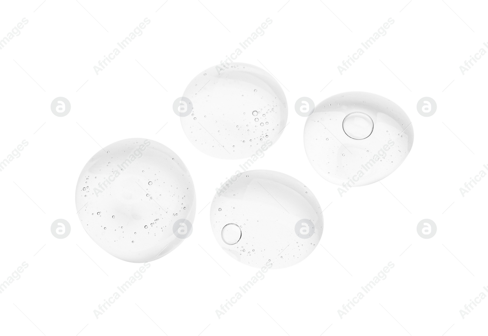 Photo of Drops of cosmetic oil on reflective surface, top view
