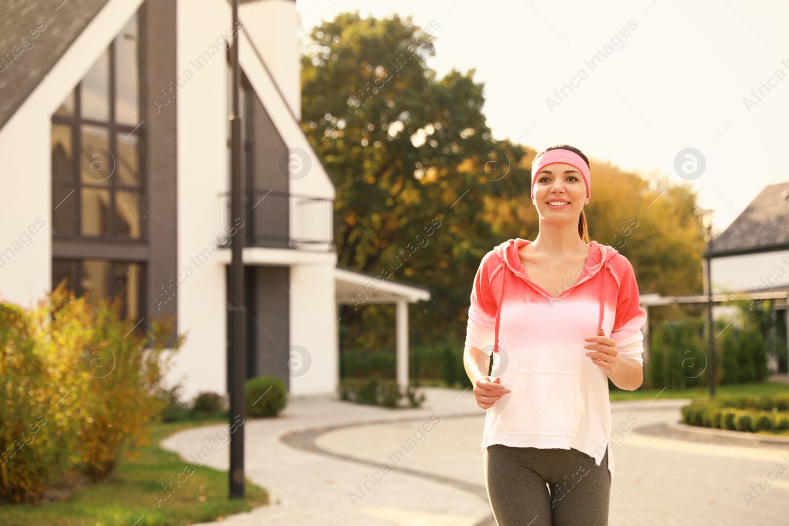 Photo of Beautiful sporty woman running on street. Healthy lifestyle