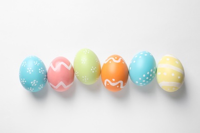 Beautiful painted Easter eggs on white background, top view