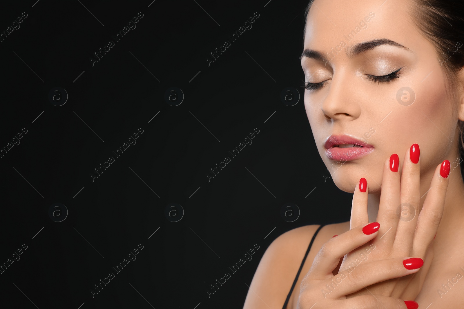 Photo of Beautiful young woman with bright manicure on black background, space for text. Nail polish trends