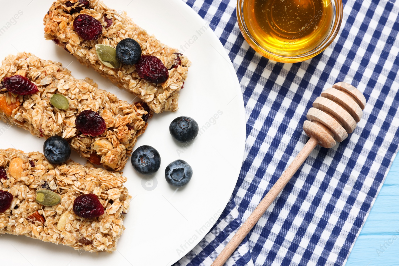 Photo of Tasty granola bars served on table, flat lay