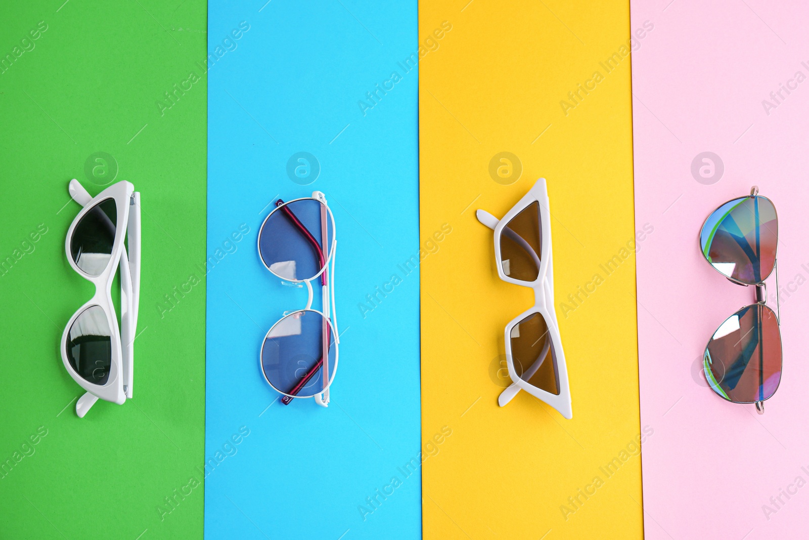 Photo of Stylish sunglasses on color background, flat lay. Summer time