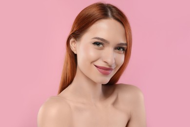 Photo of Portrait of beautiful young woman on pink background