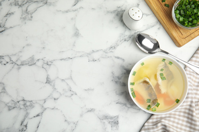 Delicious fish soup served on marble table, flat lay. Space for text