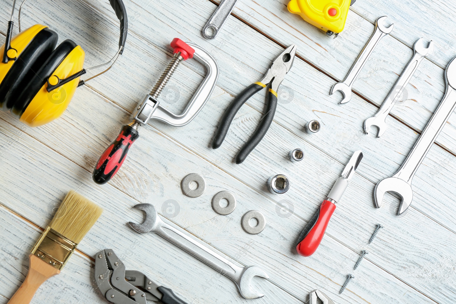 Photo of Flat lay composition with construction tools on wooden background