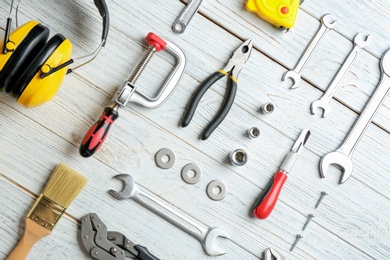 Photo of Flat lay composition with construction tools on wooden background