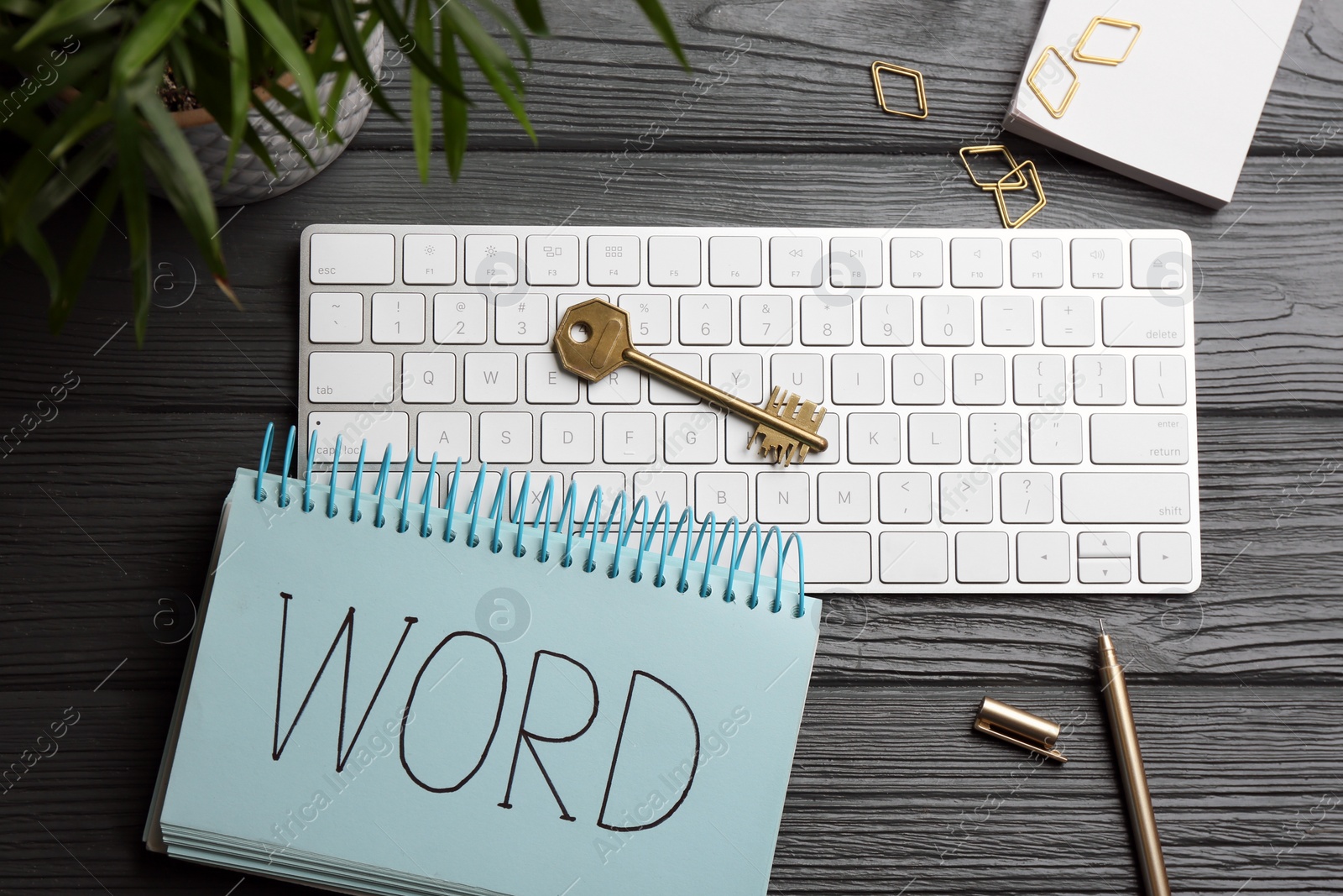 Photo of Composition with key, notebook and computer keyboard on black wooden table, flat lay. Keyword concept