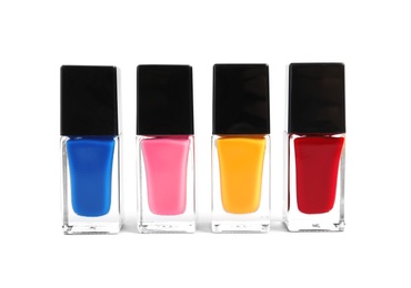 Photo of Bottles of nail polish on white background