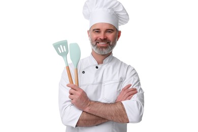 Happy chef in uniform holding kitchen utensils on white background
