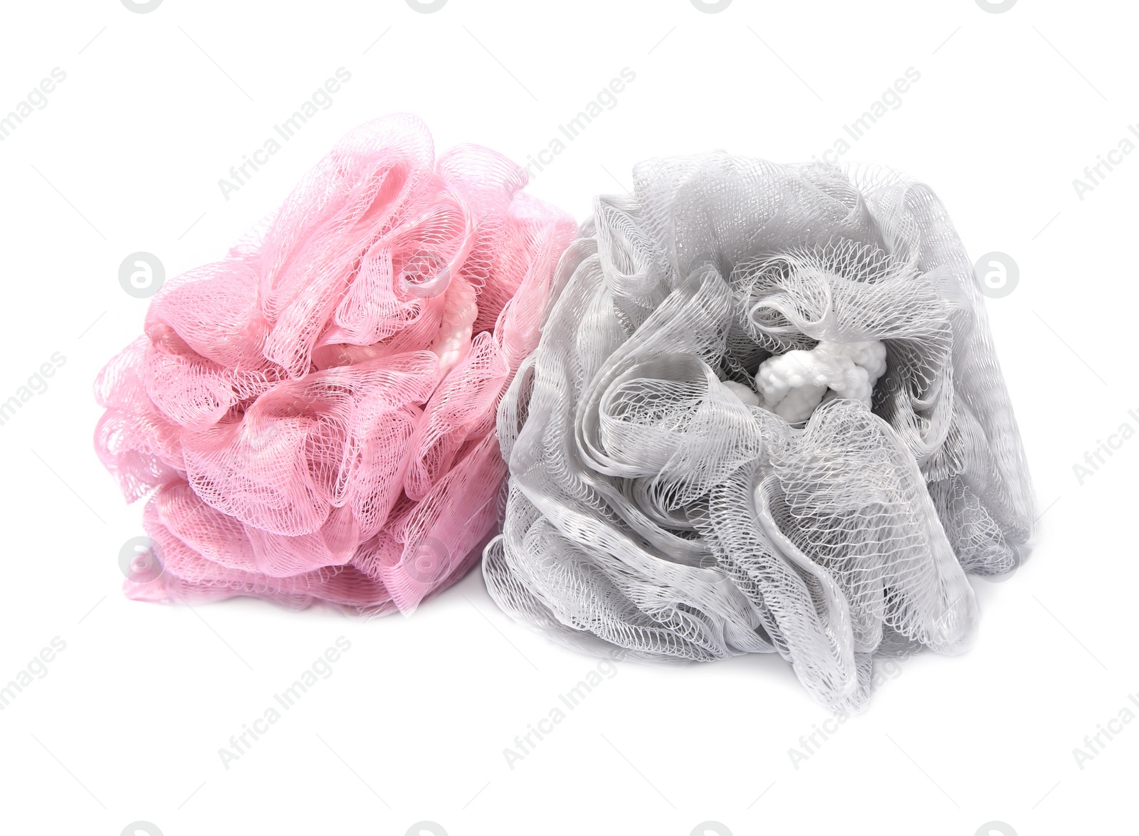 Photo of New shower puffs on white background. Personal hygiene