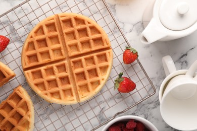 Photo of Tasty Belgian waffles with fresh berries on white marble table, flat lay